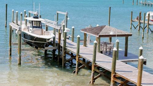 Private dock with boat and turquoise water